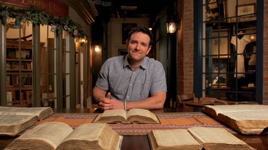 David teaching at a table of books