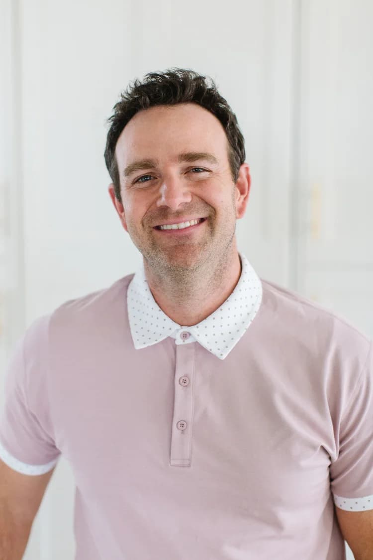 Dave Butler, smiling in a pale pink polo